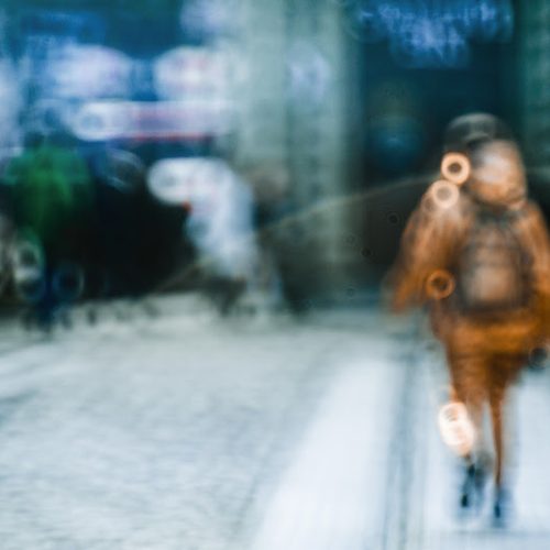 Blurred picture of person walking along the street